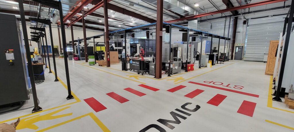 Image of the inside of OMIC's white warehouse and shop floor with their CNC machines.